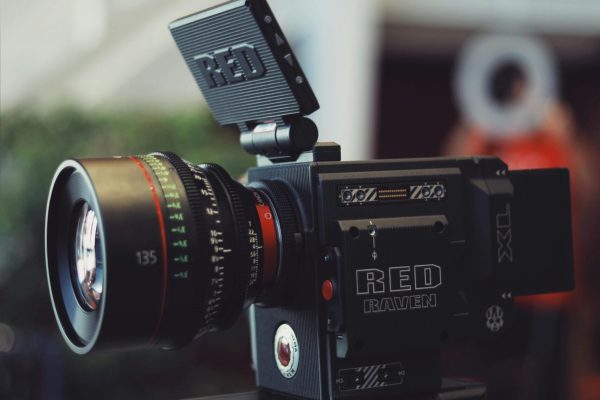 Close-up of a RED Raven video camera on a tripod, perfect for filmmaking and video production.